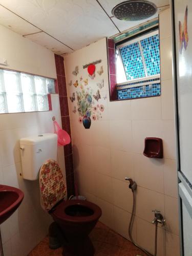 a bathroom with a toilet and a sink at Love homestay CT in Kangar