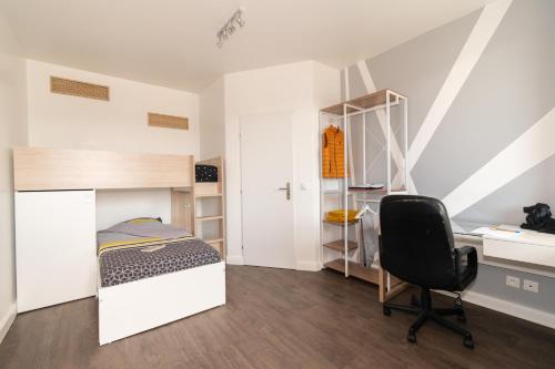 a bedroom with a bed and a desk and a chair at Private & Comfortable Apartments in Puttelange-aux-Lacs