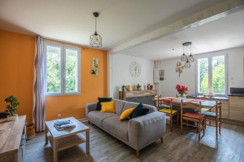 a living room with a couch and a table at gite de l'ile ste hélène in Pitres