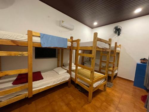 a room with three bunk beds in a room at Beachside in Anjuna