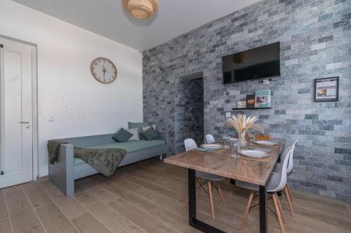 a living room with a table and a couch at Private & Comfortable Apartments in Puttelange-aux-Lacs