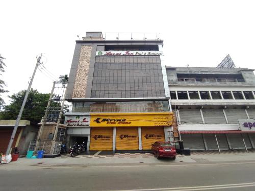 a large building with a yellow door on a street at Hotel Aavas Inn in Tezpur