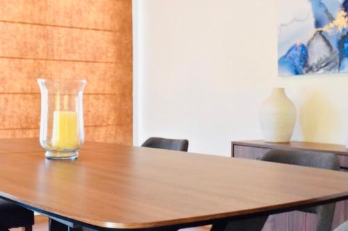 a glass of orange juice sitting on a wooden table at Ilios Villa in Larnaka