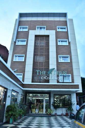 a building with a sign on the front of it at The Fern Residency Katra in Katra