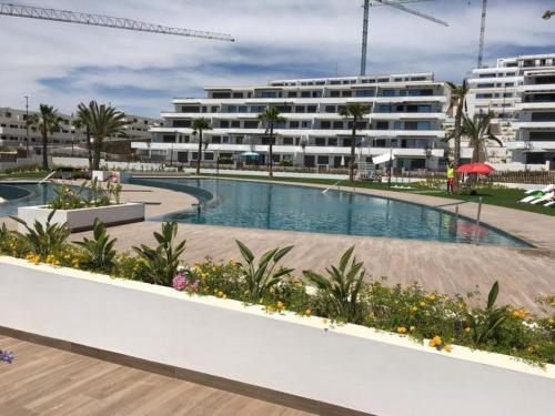 a swimming pool in front of a building at Seascape Apartamento in Finestrat
