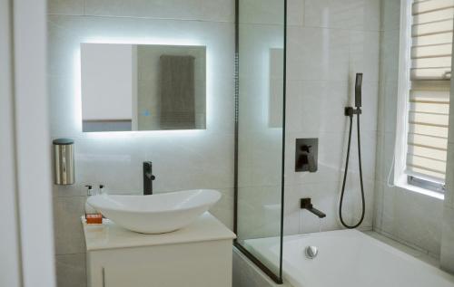 a white bathroom with a sink and a shower at Check out this beautiful 5 bed villa with pool!! in Baclayon