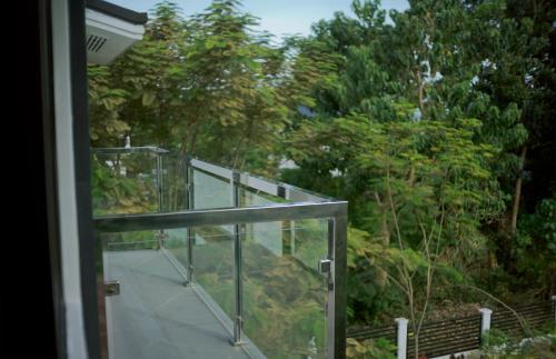 a glass balcony with a view of a walkway at Check out this beautiful 5 bed villa with pool!! in Baclayon