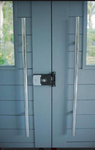 a front door of a blue house with a refrigerator at Check out this beautiful 5 bed villa with pool!! in Baclayon