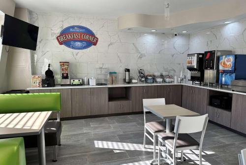 a fast food restaurant with a table and chairs at Baymont by Wyndham Noblesville in Noblesville