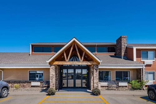 a house with a front entrance with a garage at AmericInn by Wyndham Aberdeen Event Center in Aberdeen