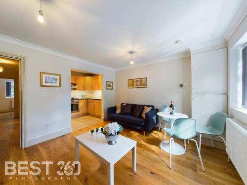a living room with a couch and a table at Redhill town centre apartment by Livingo in Redhill