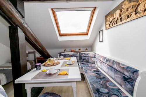 a dining room with a table and a window at Private & Comfortable Apartments in Puttelange-aux-Lacs