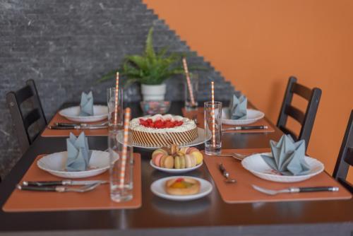 a table with a cake and candles on it at Private & Comfortable Apartments in Puttelange-aux-Lacs