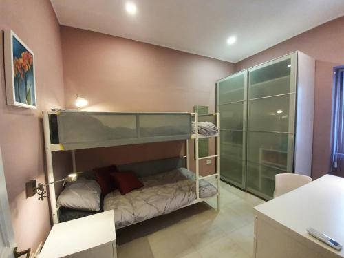 a small room with a bunk bed and a shower at Seven in Sliema