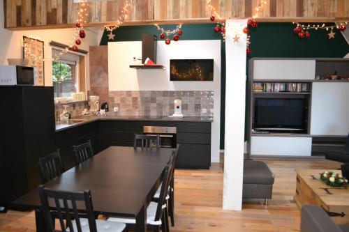 a kitchen with a table and a dining room at Chateau Brulant in Somme-Leuze