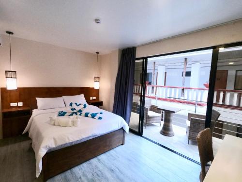 a hotel room with a bed and a balcony at Island Princess Resort Boracay, Station 2 in Boracay