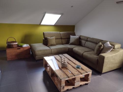a living room with a couch and a coffee table at Hasbania Vakantiewoning in Gingelom