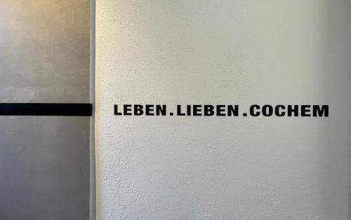 a sign on a wall with the words liberalism liberalism coefficient at Moselfreude in Cochem