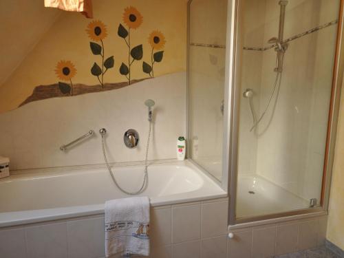 a bathroom with a shower and a bath tub with a shower at Lovely Apartment in Frankenberg with Barbecue in Frankenberg