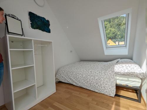 a small bedroom with a bed and a window at Apartment in Mariazell near ski area in Mariazell