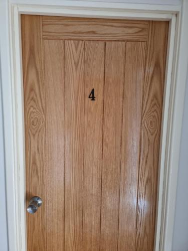 a wooden door with the number four on it at Small single bed in Oxford