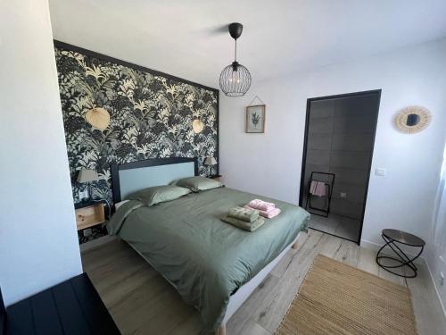 a bedroom with a green bed with a floral wallpaper at Casa Azzura in Bastia