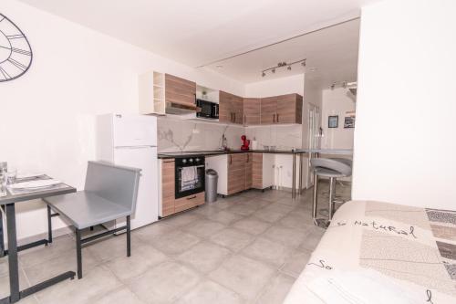 a large kitchen with a table and chairs in a room at Private & Comfortable Apartments in Puttelange-aux-Lacs