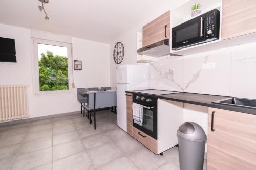 a kitchen with a sink and a stove top oven at Private & Comfortable Apartments in Puttelange-aux-Lacs