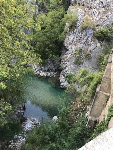 a pool of water on a rocky hillside at Bujtina Arlindi in Valbonë