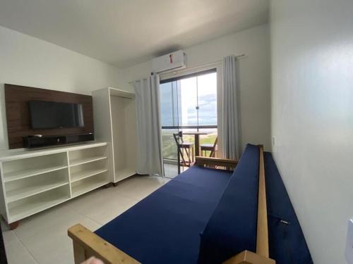 a living room with a blue slide in front of a window at Condominio Boa Vista in Pontal do Paraná