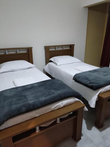 two beds sitting next to each other in a room at Sevili Garden Hotel in Arujá