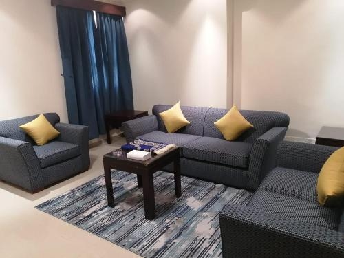 a living room with two couches and a coffee table at Makarem Najd Funished Units 1 in Riyadh