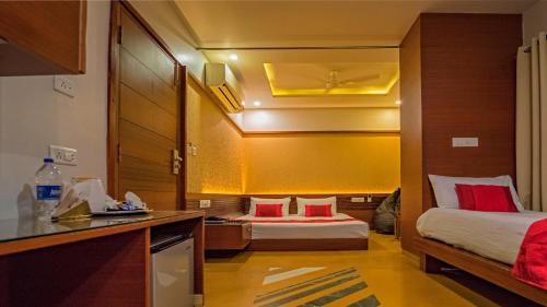 a hotel room with two beds and a kitchen at Uddhav Vilas A Family Hotel in Udaipur