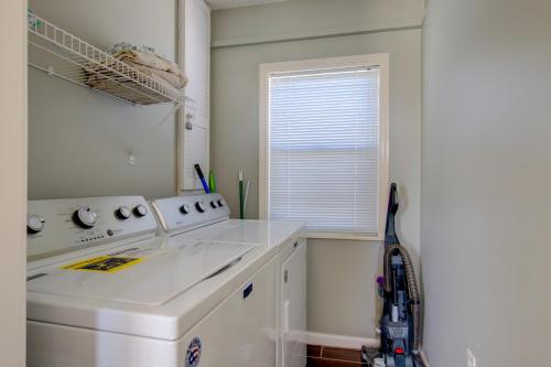 a kitchen with a washing machine and a window at Living the Dream in Surf City