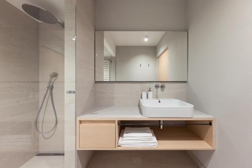 a bathroom with a sink and a mirror at Solis Apartments in Lana
