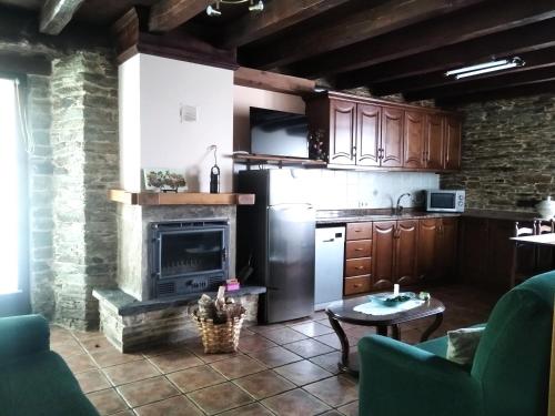 a kitchen with a refrigerator and a stove at La Posada de Oscos in Santa Eulalia de Oscos