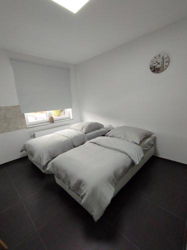 a bedroom with a large bed with white sheets at Aparthotel Siegen in Siegen