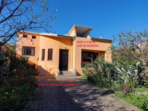 a building with a sign that reads next a cave inn in guatemala at Townhouse Maria in Kutaisi