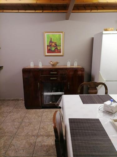 a kitchen with a table and a refrigerator at Studio P & P Polylimnio Waterfalls in Dhouvraíika