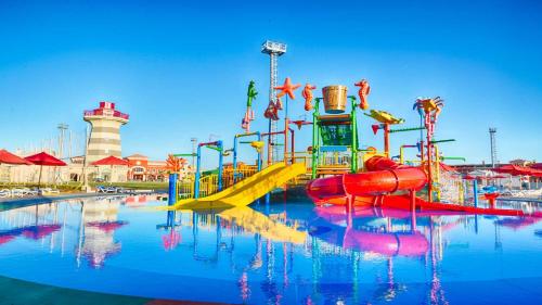 a water park with a playground with a slide at Fully Equipped Apartments Pool & Mountains View in Porto Sharm Resort in Sharm El Sheikh