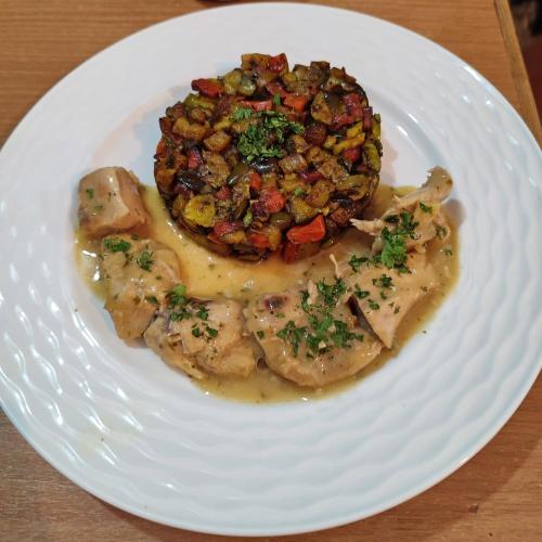 a white plate of food with meat and vegetables at Maison d'hôtes Tigminou - Adults Only in Aït Ben Haddou