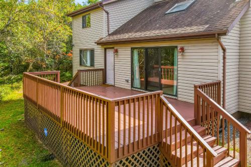 a house with a wooden deck in the yard at House in the Woods in Albrightsville