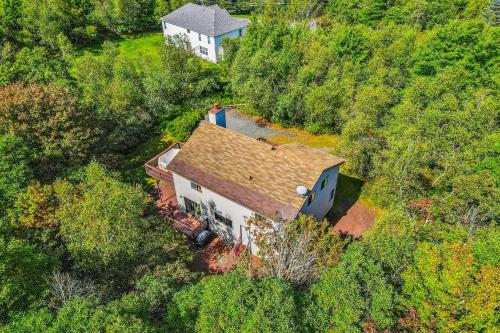 a man standing on the roof of a house at House in the Woods in Albrightsville