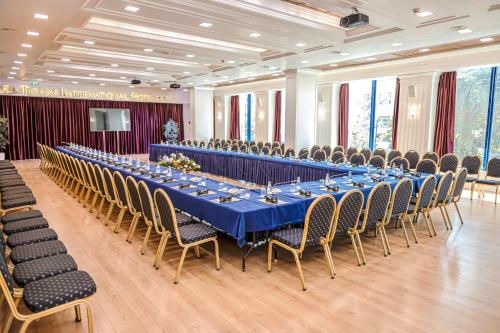 a large banquet hall with a long table and chairs at Tirana International Hotel & Conference Center in Tirana