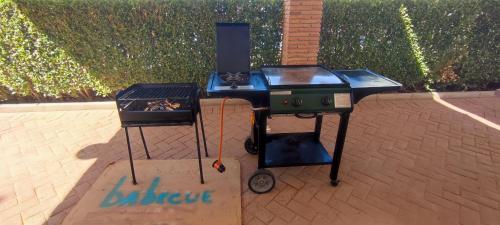 a bbq and a grill on a brick floor at Vivienda Turística Rural in Granada