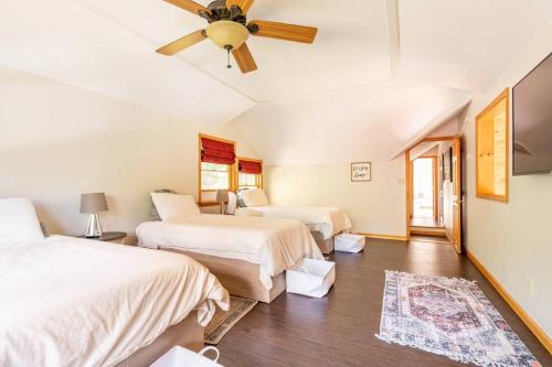 a bedroom with two beds and a ceiling fan at Beautiful mountain home with gorgeous meadow views in Hunter