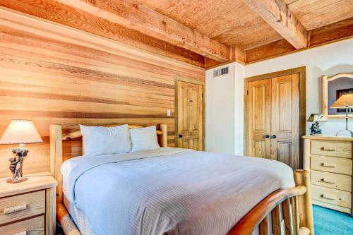 a bedroom with a bed and a wooden wall at Snowdream in Ponderosa Fairway Estates