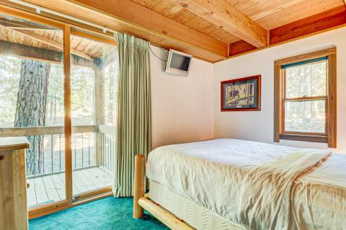 a bedroom with a bed and a large window at Snowdream in Ponderosa Fairway Estates