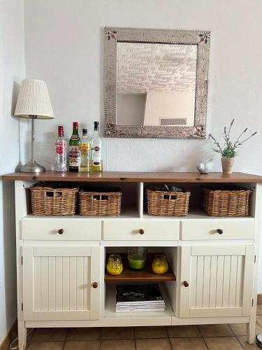 - une commode blanche avec un miroir dans la chambre dans l'établissement Le Bourg, à Concots