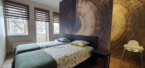 a bedroom with two beds and a large wooden wall at City Centre Apartment in Rēzekne